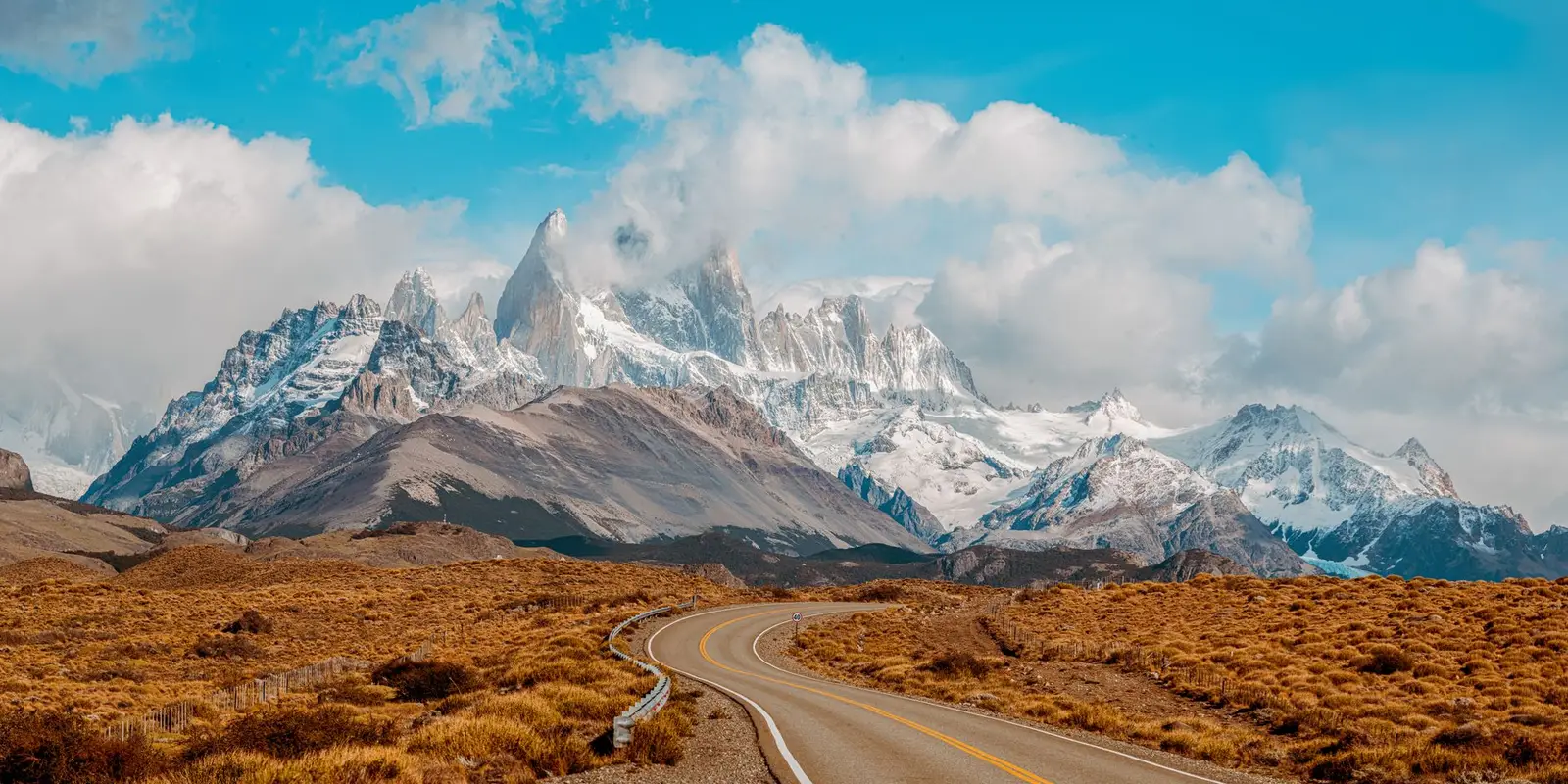 Discover the stunning view of Mount Fitz Roy in Patagonia, Argentina, with a winding road leading to the majestic peaks.