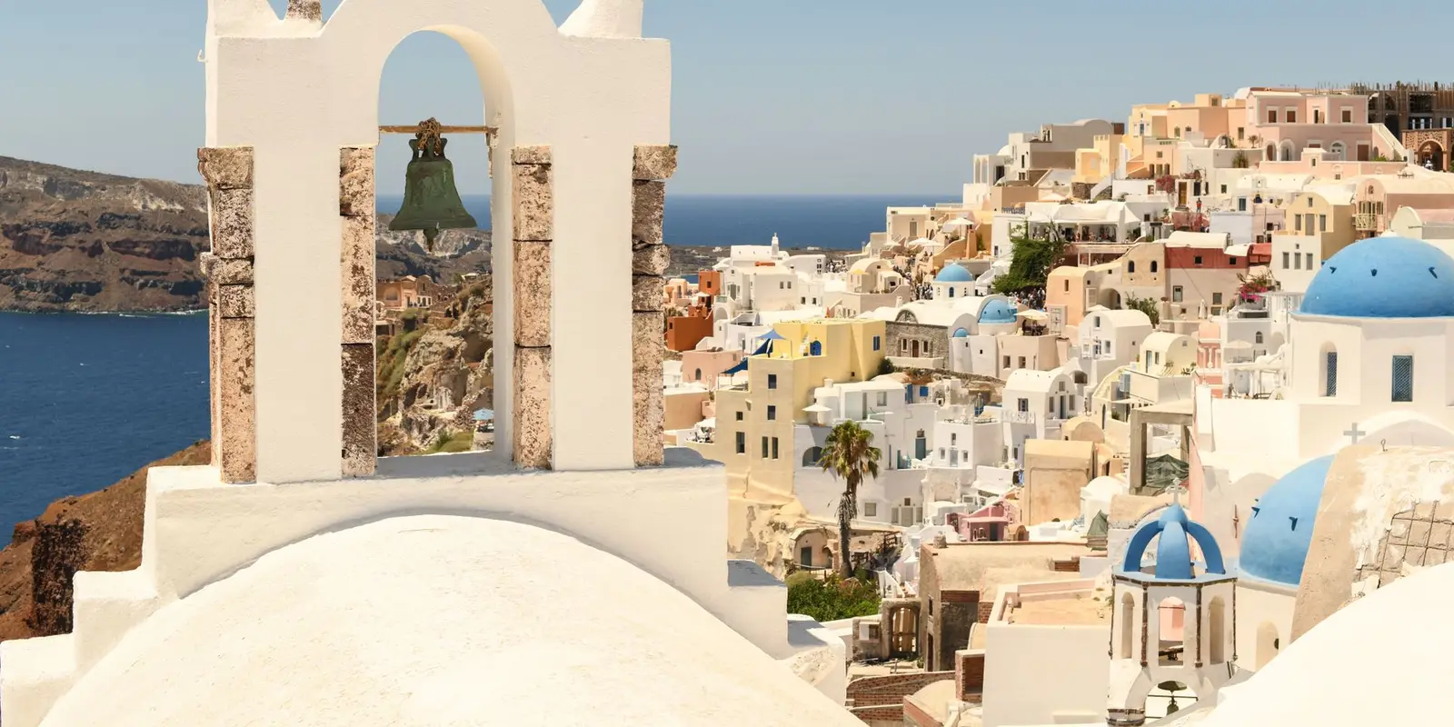 Beautiful view of Santorini, Greece, featuring iconic whitewashed buildings and the Aegean Sea.
