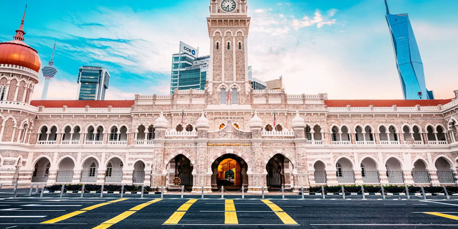 The iconic Sultan Abdul Samad Building against a clear sky in Kuala Lumpur, Malaysia.