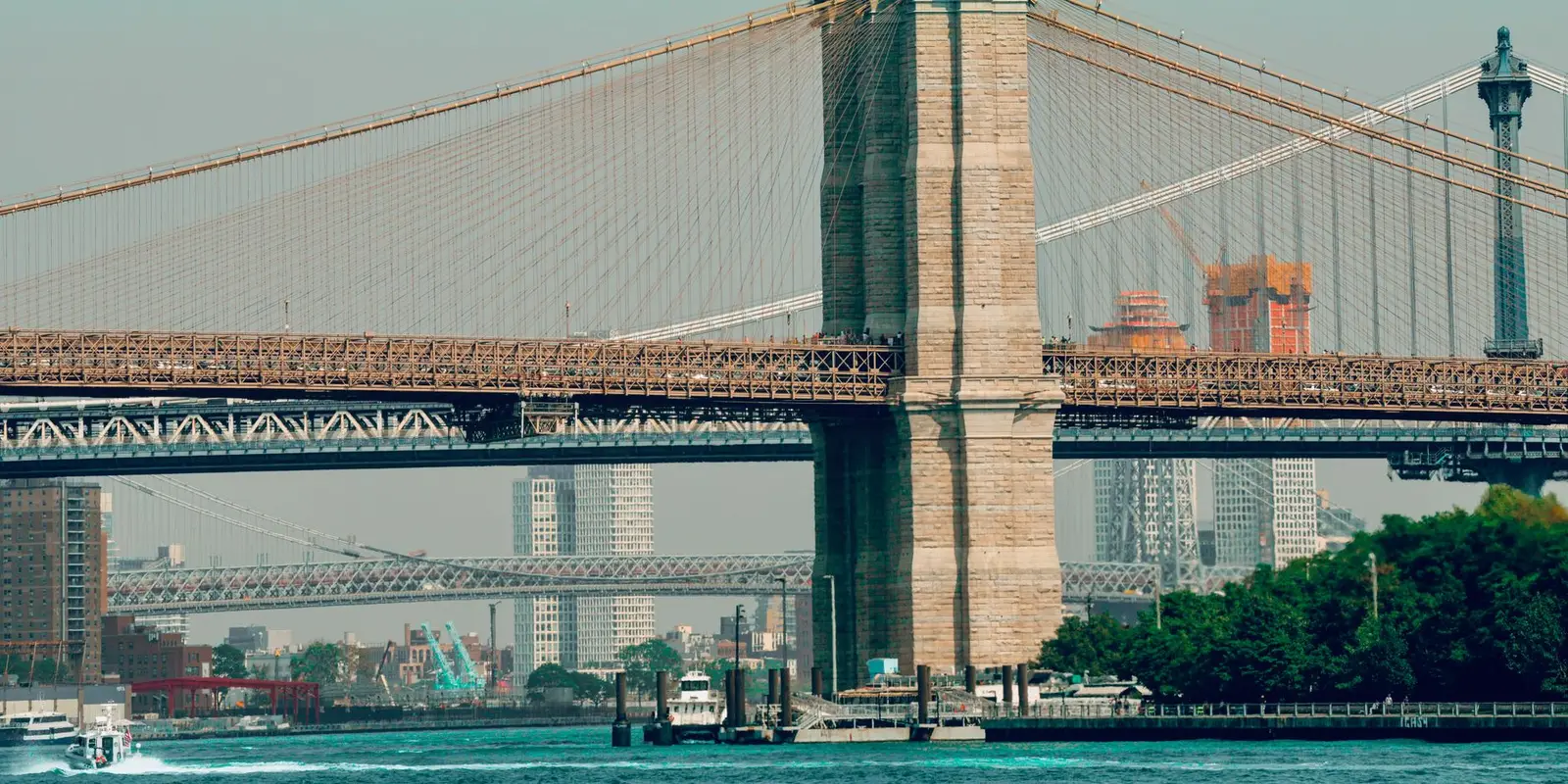 Scenic view of the iconic Brooklyn Bridge with New York City skyline in the background.